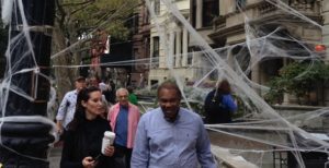 LW! walkers slip under the spiders web on W. 69th Street